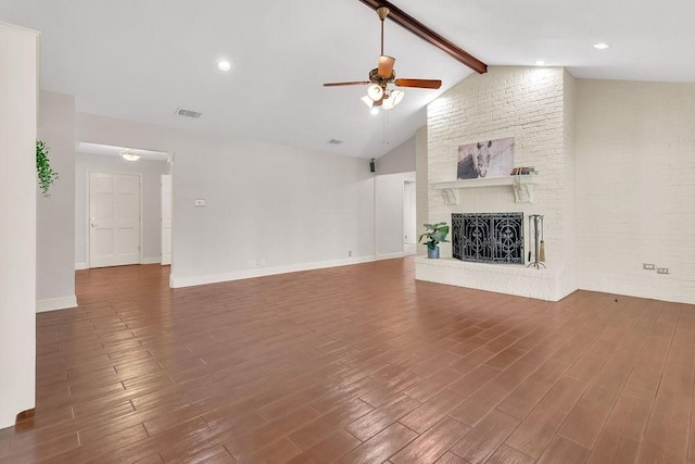 unfurnished living room featuring a fireplace, lofted ceiling with beams, and dark hardwood / wood-style floors