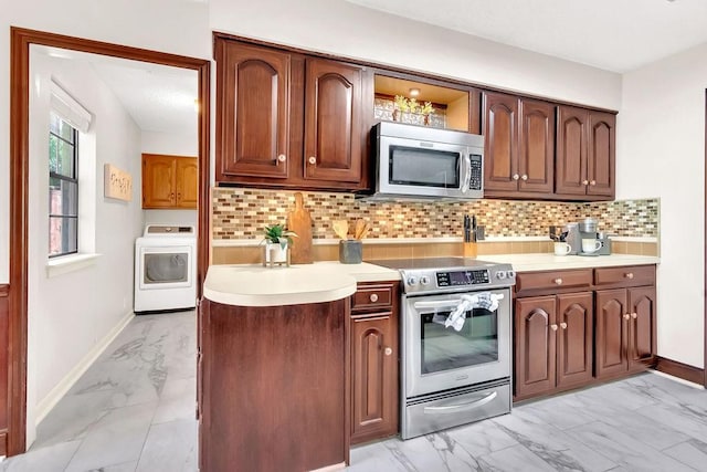 kitchen with tasteful backsplash, washer / clothes dryer, and stainless steel appliances