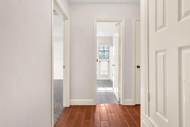 hall featuring hardwood / wood-style flooring and a textured ceiling