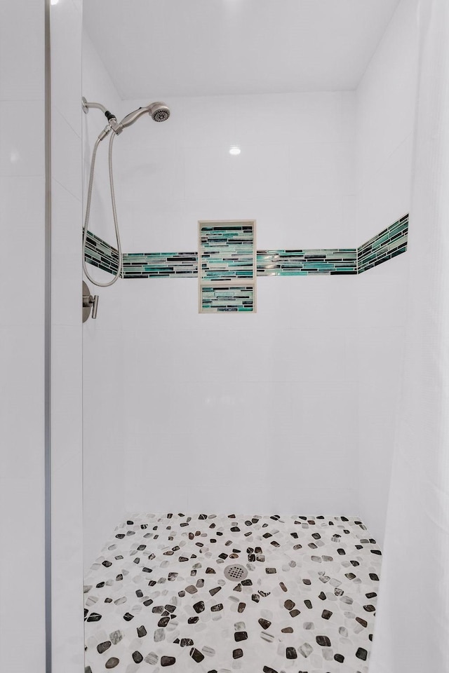 bathroom with a tile shower