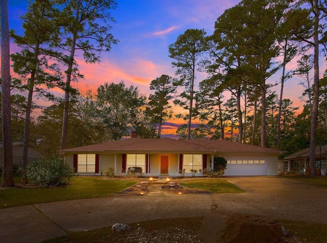 ranch-style house with a lawn and a garage