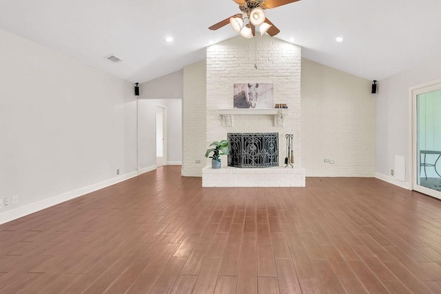 unfurnished living room featuring ceiling fan, a fireplace, wood-type flooring, and lofted ceiling