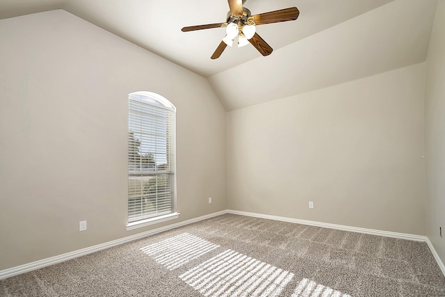 carpeted empty room with ceiling fan and lofted ceiling