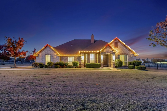 mediterranean / spanish-style house with a lawn