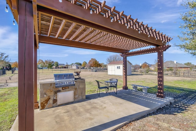 view of patio / terrace featuring area for grilling, fence, an outdoor structure, and a pergola