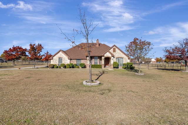 ranch-style home featuring a front yard