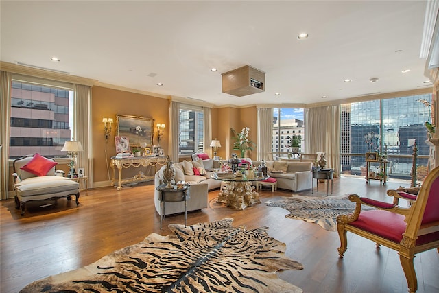 living room with crown molding and light hardwood / wood-style flooring