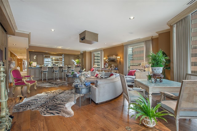 living room with ornamental molding and wood-type flooring