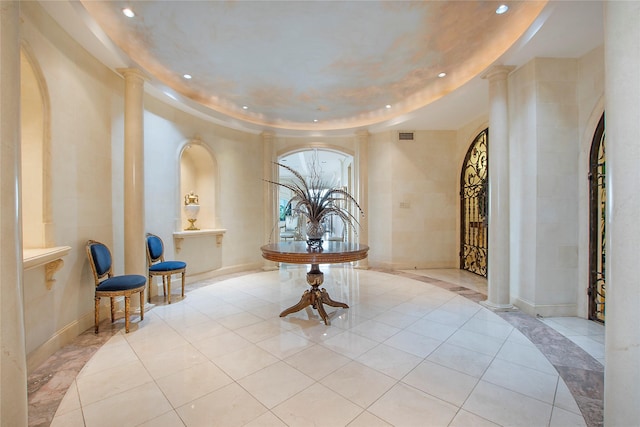 8181 Douglas Ave Unit 800, Dallas, TX 75225 - foyer with decorative columns, recessed lighting, light tile patterned floors, and a tray ceiling