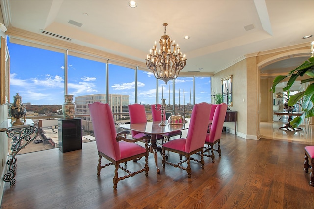 dining room with expansive windows, dark hardwood / wood-style floors, a chandelier, and a tray ceiling