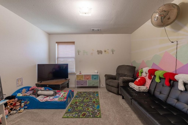 recreation room featuring light colored carpet and a textured ceiling