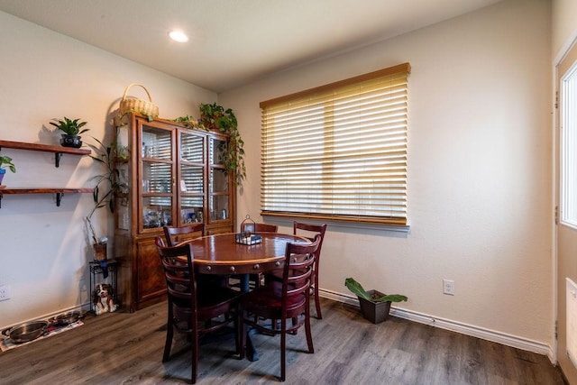 dining space with a healthy amount of sunlight and dark wood-type flooring