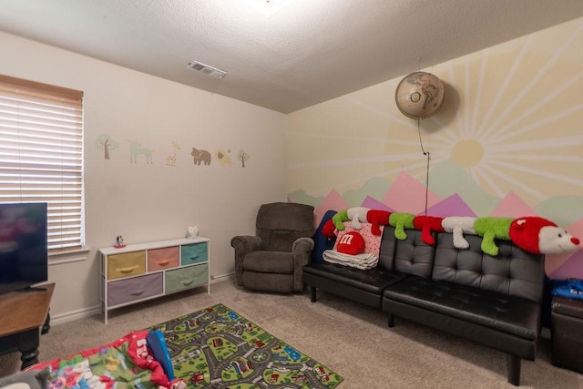 rec room with a textured ceiling, light carpet, and a wealth of natural light