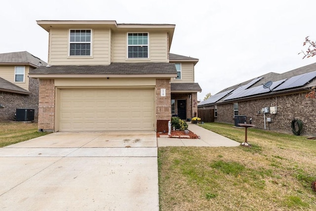 view of front of home featuring a front yard, central AC, and a garage