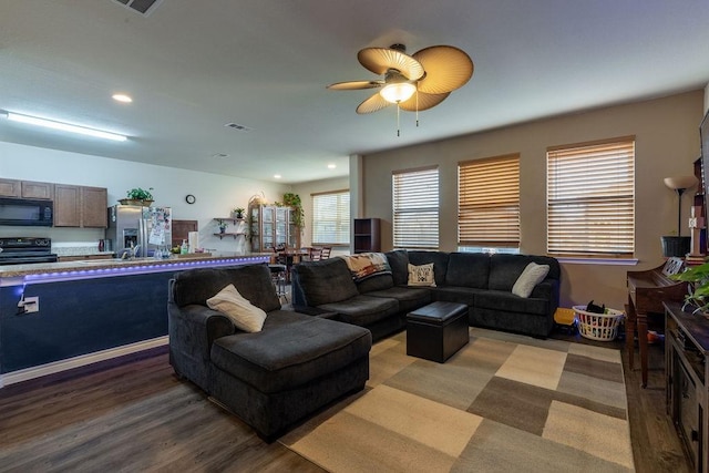 living room featuring ceiling fan, hardwood / wood-style floors, and sink