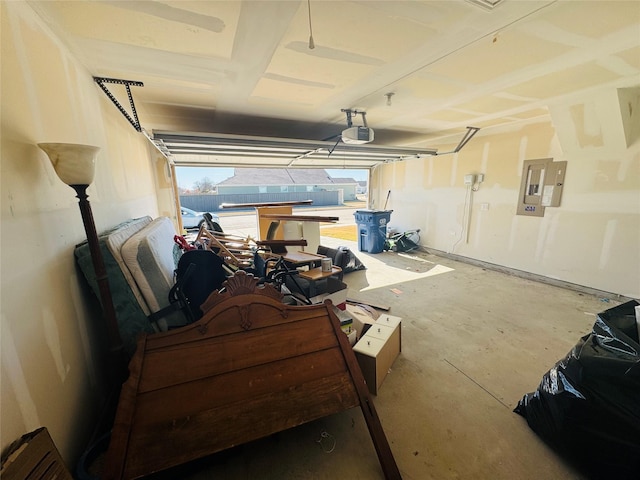 garage featuring a pool, a garage door opener, and electric panel