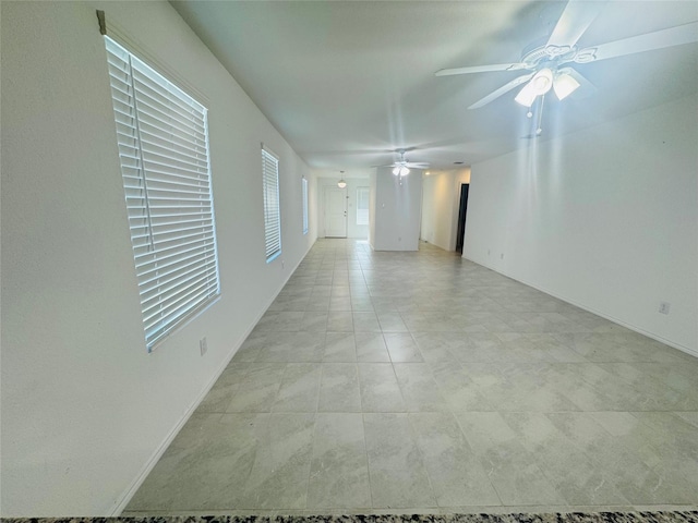 unfurnished room with ceiling fan and light tile patterned floors