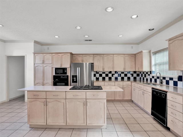 kitchen with light brown cabinets, a kitchen island, ornamental molding, and black appliances