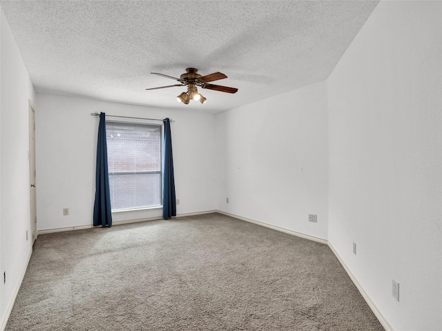 spare room with carpet, a textured ceiling, and ceiling fan