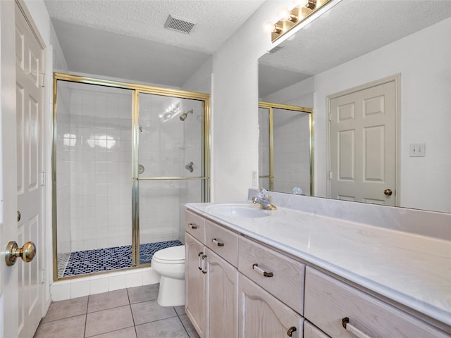 bathroom featuring toilet, a textured ceiling, tile patterned floors, and a shower with shower door