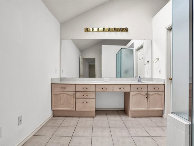 bathroom featuring vanity, tile patterned floors, and lofted ceiling