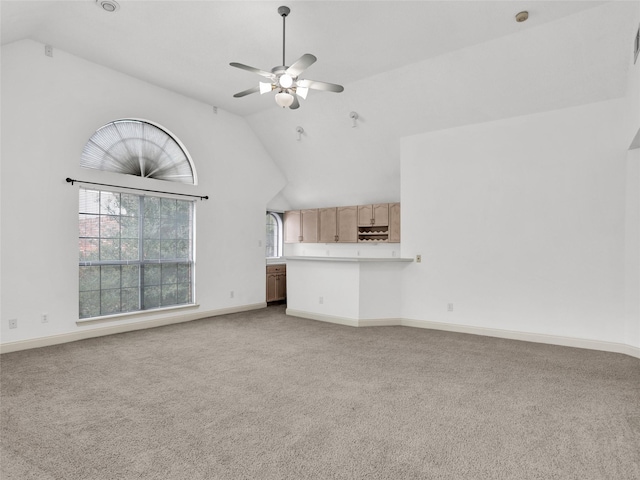 unfurnished living room featuring carpet, high vaulted ceiling, and ceiling fan