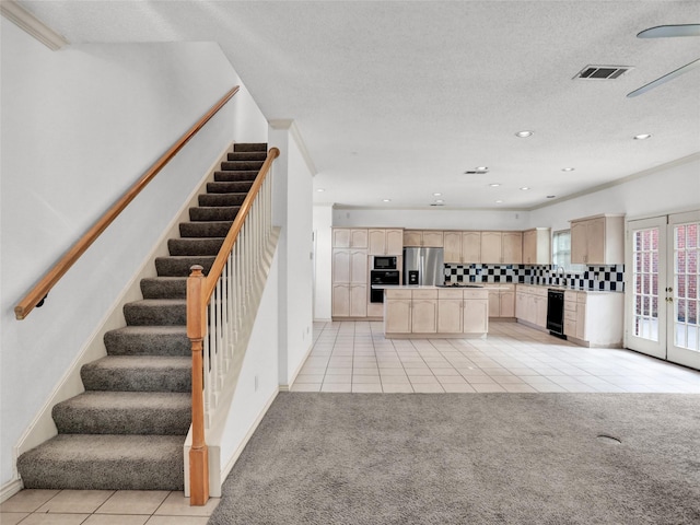 kitchen with light brown cabinets, french doors, backsplash, black appliances, and ornamental molding