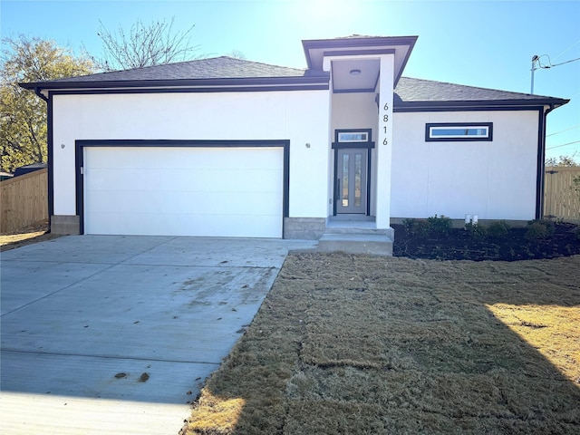 view of front facade with a garage and a front lawn