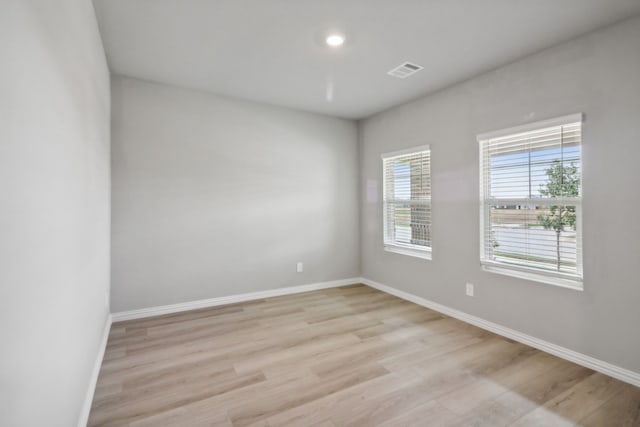 unfurnished room with light hardwood / wood-style floors