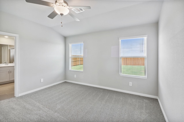 empty room with light carpet, vaulted ceiling, ceiling fan, and sink