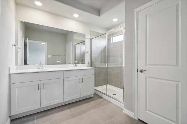 bathroom with vanity, tile patterned floors, and a shower with door