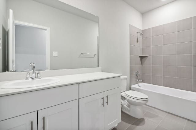 full bathroom with tile patterned floors, vanity, tiled shower / bath combo, and toilet