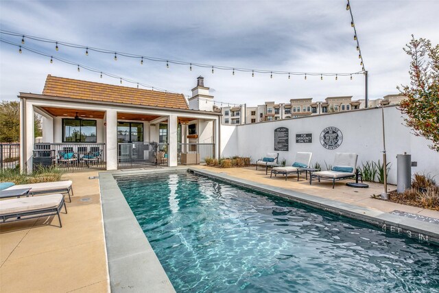 view of swimming pool with fence, a fenced in pool, and a patio