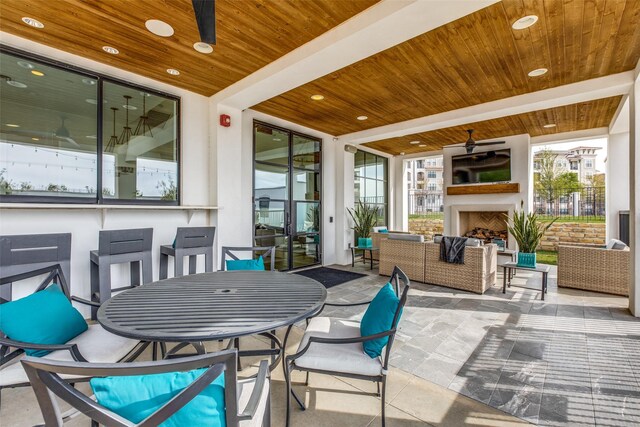 view of patio / terrace with an outdoor living space with a fireplace