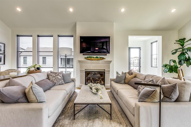 living area featuring recessed lighting and a fireplace