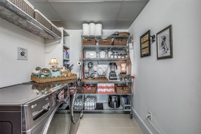 laundry area featuring laundry area, tile patterned flooring, baseboards, and washer and dryer