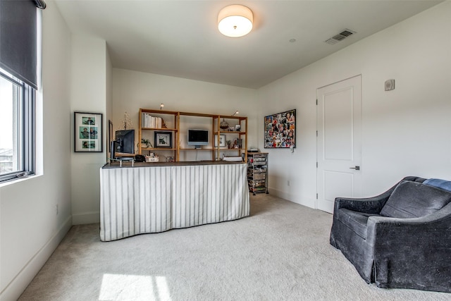 home office with baseboards, visible vents, and light colored carpet