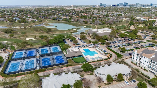 aerial view with golf course view and a water view