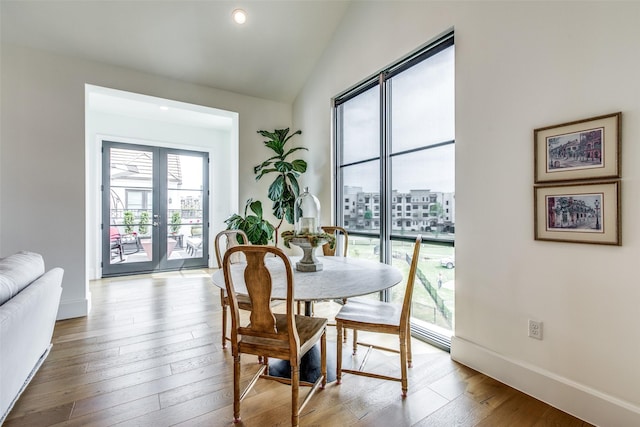 dining area featuring french doors, recessed lighting, vaulted ceiling, baseboards, and hardwood / wood-style flooring