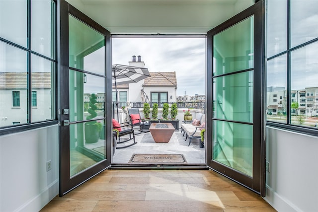 entryway featuring a view of city, baseboards, and wood finished floors