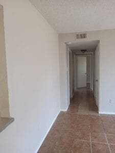 hallway featuring a textured ceiling and tile patterned floors