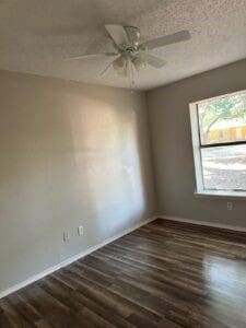 empty room featuring a textured ceiling, dark hardwood / wood-style flooring, and ceiling fan