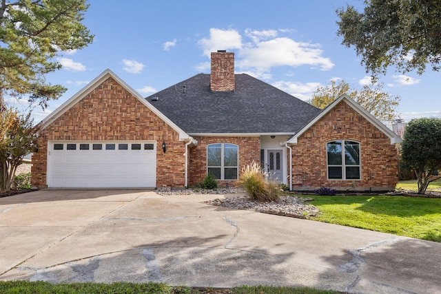 front facade featuring a garage and a front lawn