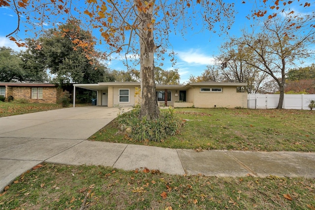 ranch-style house featuring a front yard and a carport