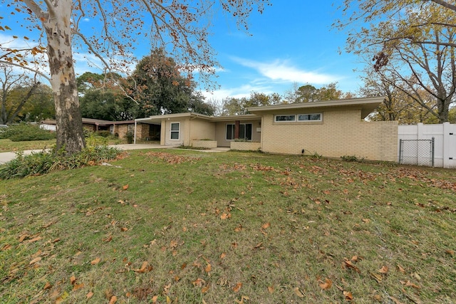 back of property featuring a yard and a carport