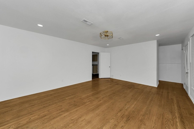 empty room with hardwood / wood-style flooring