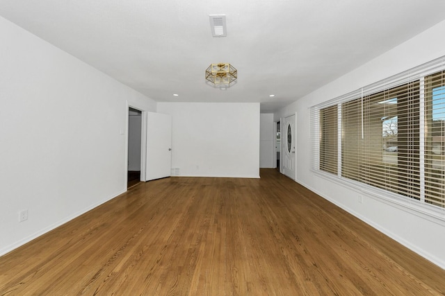 spare room with wood-type flooring