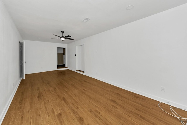 empty room with hardwood / wood-style flooring and ceiling fan