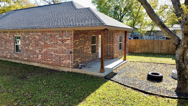 view of home's exterior featuring a patio and a lawn