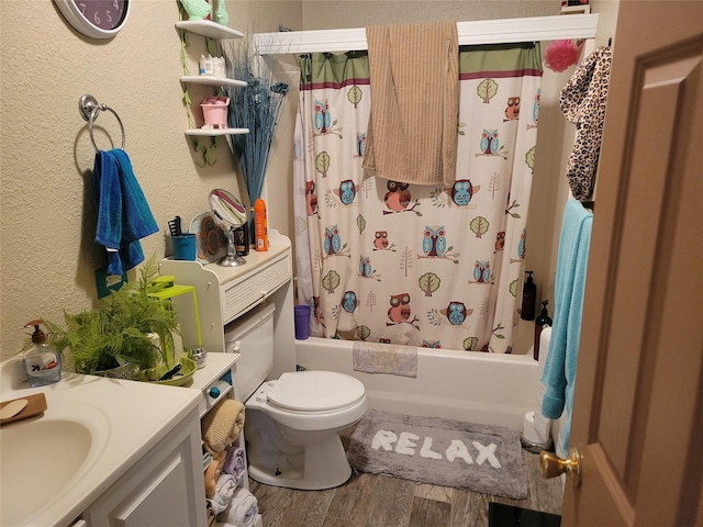 full bathroom featuring toilet, hardwood / wood-style floors, vanity, and shower / bath combo with shower curtain